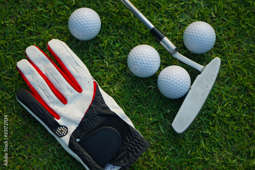 Golf equipment on green grass.