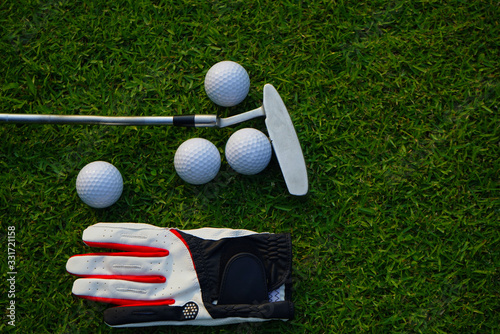 Golf equipment on green grass.