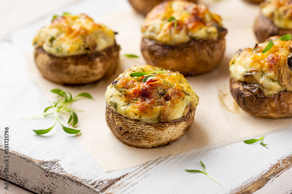 Stuffed mushrooms with cheese, delicious baked appetizer, traditional starter, golden crust.