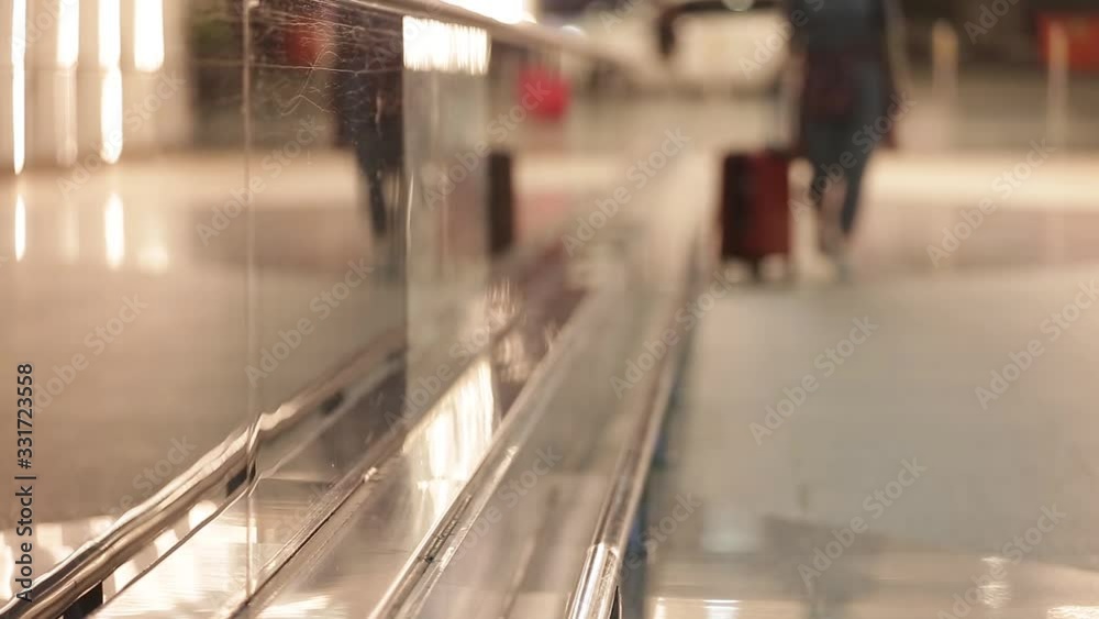 Close up of woman's legs pulling suitcase in modern airport terminal wearing smart casual style clothes walking away. Entering to the airport. Legs with the baggage walking to airport terminal. Close up of woman's legs pulling suitcase in modern airport terminal wearing smart casual style clothes walking away. Entering to the airport. Legs with the baggage walking to airport terminal.