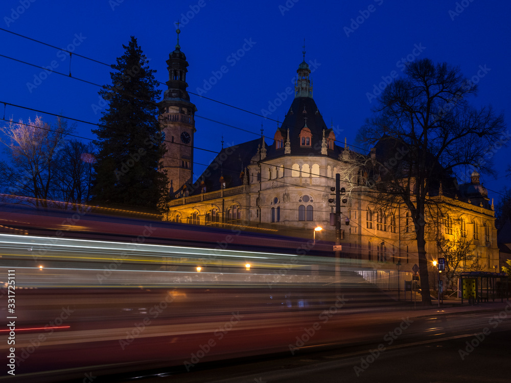 Fototapeta premium North Czech museum Art Nouveau in Liberec. Evening scene with lights by passed tram.