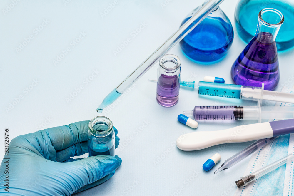 Female hand holds a test tube. Laboratory studies of coronavirus. Worldwide pandemic COVID-19, 2019-nCoV, SARS-CoV-2 Female hand holds a test tube. Laboratory studies of coronavirus. Worldwide pandemic COVID-19, 2019-nCoV, SARS-CoV-2