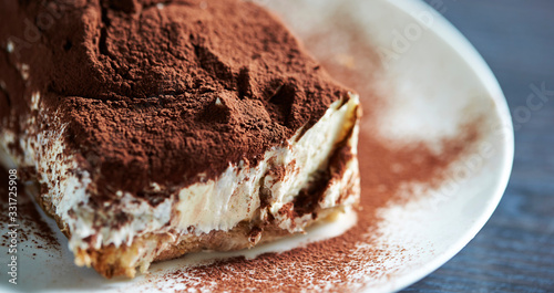 Tableau sur toile Tiramisu cake on white plate