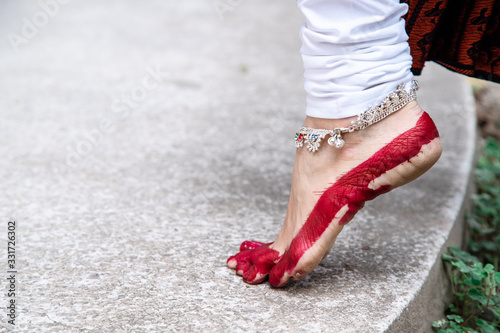 dance form indian classical feet with ghungru. Kathak Girl tying ghungaroo. close up, copy space. classical Indian culture and traditions photo