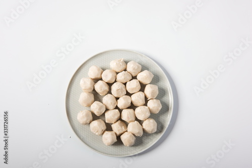 Meatballs made of fish are in delicate plates, isolated in white background