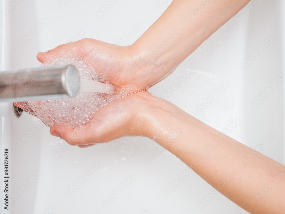 Fototapeta premium pair or children's hands being washed