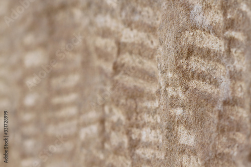 The background pattern on the vertical cement floor.