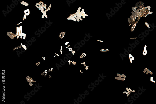 Real Wood Letters Flying away Isolated on Black Background