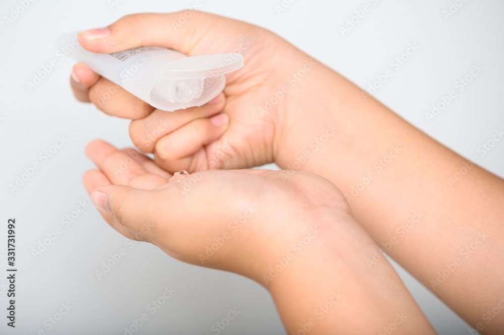 Hands Applying Sanitizer Gel. hands using wash hand sanitizer gel dispenser, against Novel coronavirus or Corona Virus Disease (Covid-19) at public train station. Antiseptic, Hygiene and Healthcare Hands Applying Sanitizer Gel. hands using wash hand sanitizer gel dispenser, against Novel coronavirus or Corona Virus Disease (Covid-19) at public train station. Antiseptic, Hygiene and Healthcare