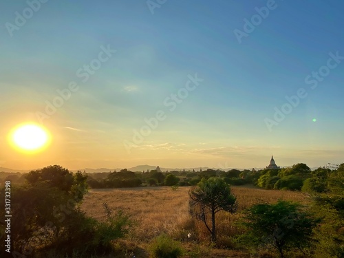 The evening landscape of the Bagan with flare sun  World Heritage Site Myanmar