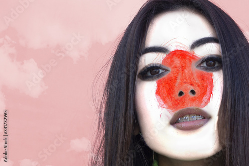 Fototapeta Naklejka Na Ścianę i Meble -  Flag of Japan painted on a face of a smiling japanese young woman. Copyspace.