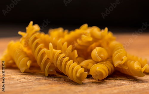  Fusili pasta closeup on wooden board