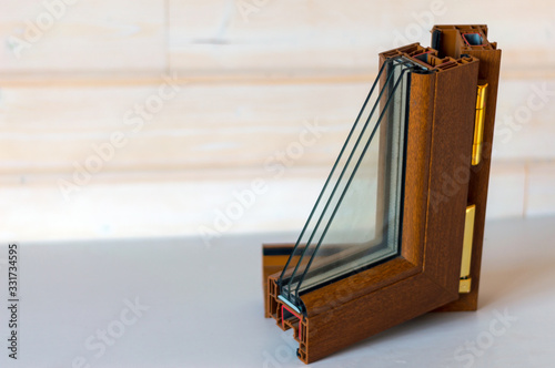 A sample of a plastic double-glazed window under a tree.