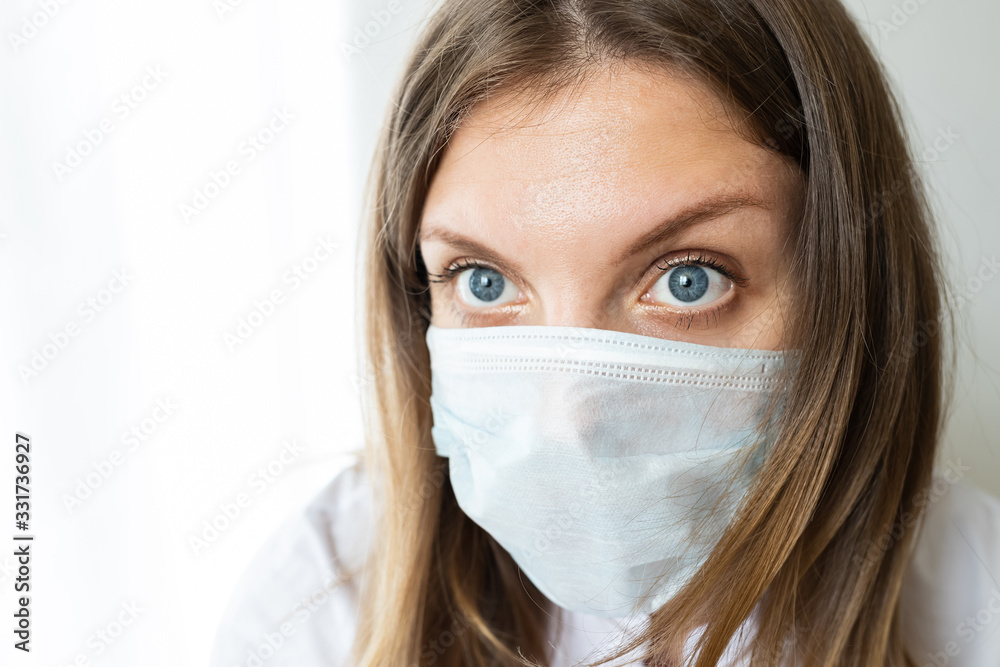 Close up of a female nurse putting on a mask to protect from airborne respiratory diseases such as the flu, coronavirus, ebola, TB, etc copyspace Close up of a female nurse putting on a mask to protect from airborne respiratory diseases such as the flu, coronavirus, ebola, TB, etc copyspace