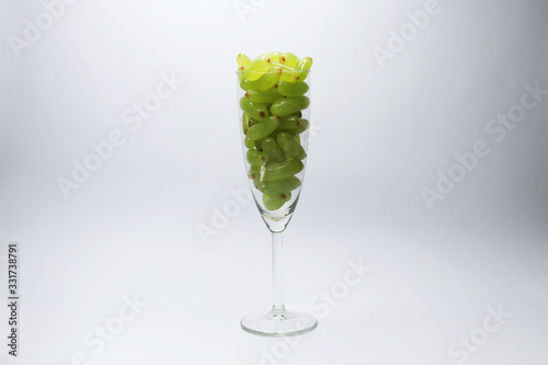 green grape in wine glass