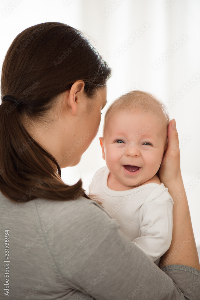 Portrait of happy mother and baby, parent and little kid relaxing at home. Family having fun together. Portrait of happy mother and baby, parent and little kid relaxing at home. Family having fun together.