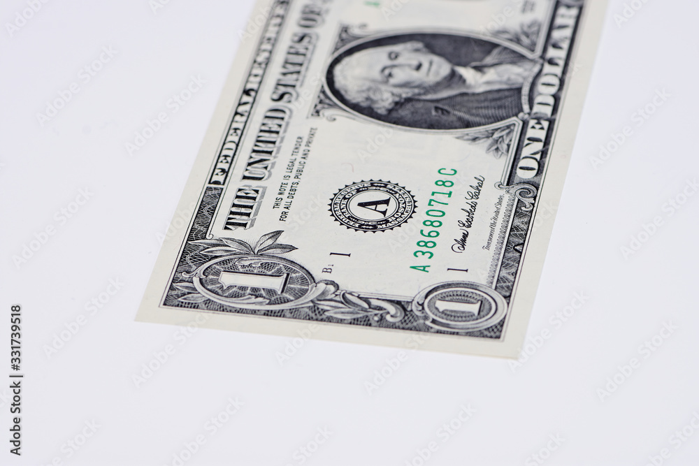 part of one Dollar bill on white surface with copy space