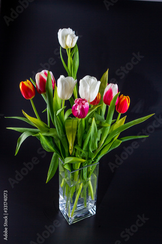Bunches of tulips in a glass vase