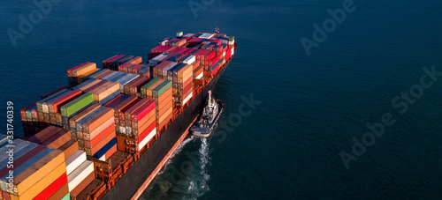 Container cargo ship business commercial trade import export logistic transportation container box oversea worldwide by container vessel boat freight shipping maritime with tugboat. © Kalyakan