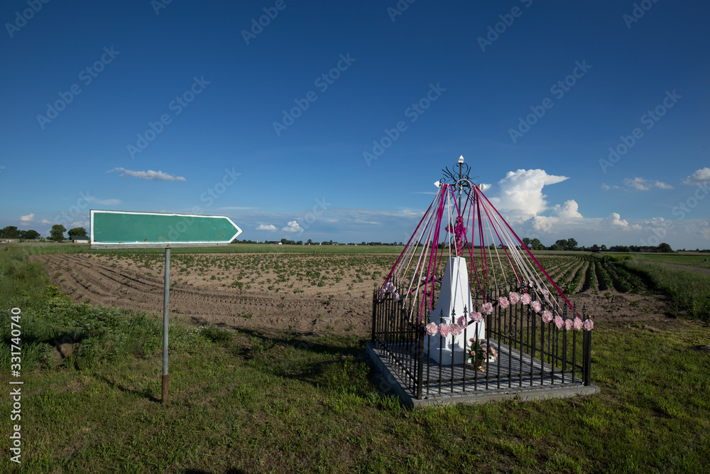 Chapel in the field with a signpost