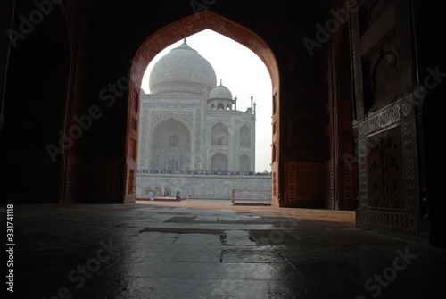 A view of the taj mahal from the opening door of structure