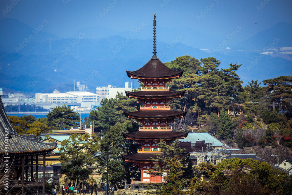 Miyajima, Japan - January 02, 2020: Cityscape to the Walking Tourists and Itsukushima streets Miyajima, Japan - January 02, 2020: Cityscape to the Walking Tourists and Itsukushima streets