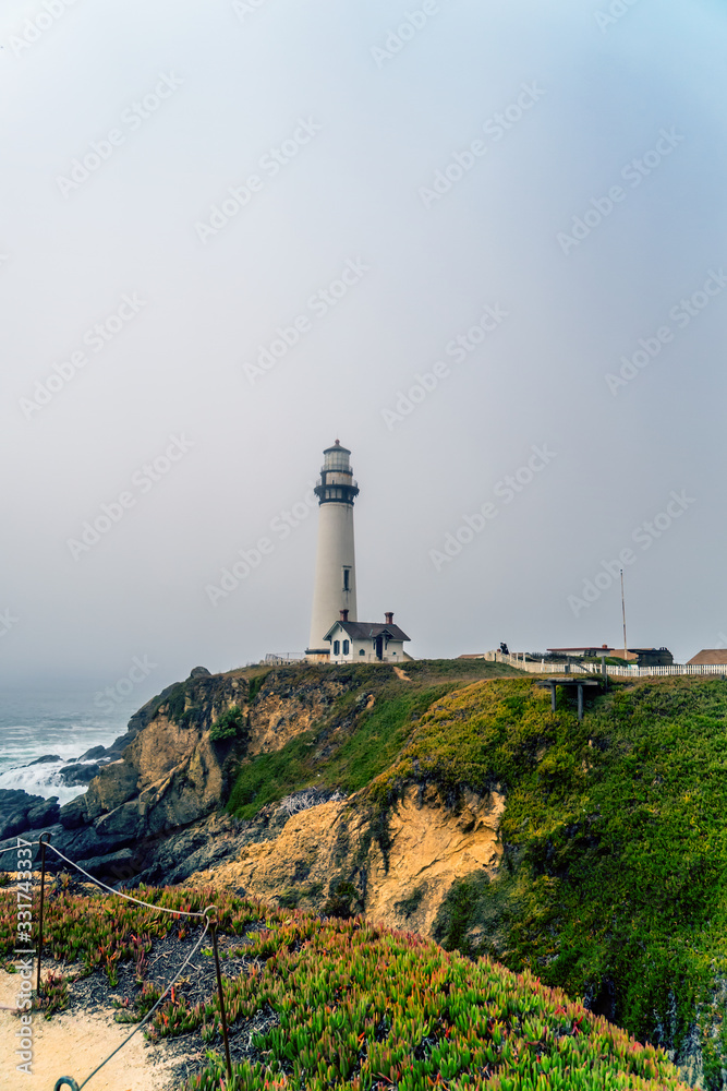 lighthouse on a foggy morning on the coast of california