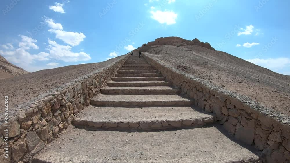 Yazd, Iran - May 2019: Tourists walking in the stairs of Ruins of Zoroastrians Dakhmeh Towers of Silence in Yazd city Yazd, Iran - May 2019: Tourists walking in the stairs of Ruins of Zoroastrians Dakhmeh Towers of Silence in Yazd city