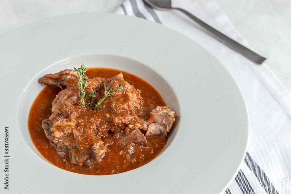 Lamb stew with aromatic herbs seen from above Lamb stew with aromatic herbs seen from above