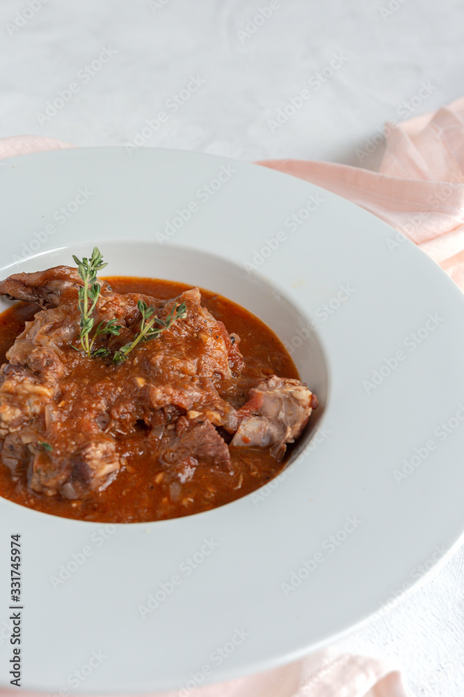 Lamb stew with aromatic herbs seen from above Lamb stew with aromatic herbs seen from above