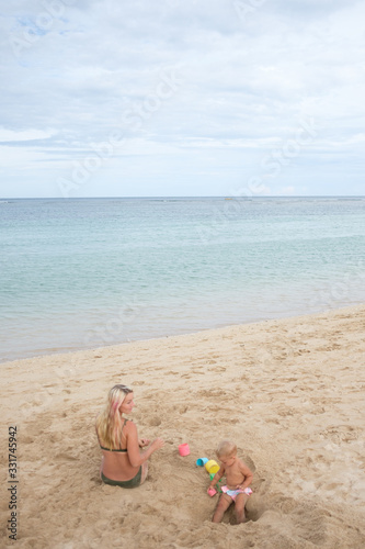 Fototapeta Naklejka Na Ścianę i Meble -  Pregnant mother and kid on the beach, happy mothers day
