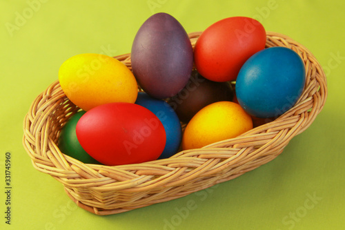 Easter eggs colors in basket green background