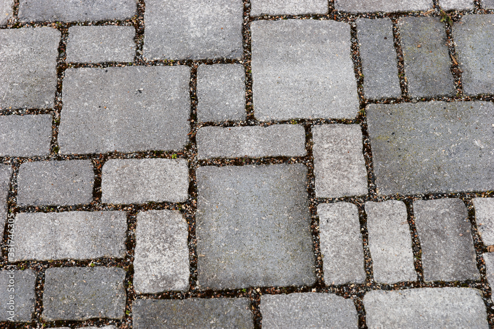 Various gray brick paving stones on a sidewalk Various gray brick paving stones on a sidewalk