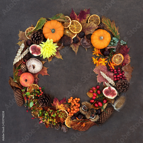 Autumn harvest festival wreath composition with a variety of natural flora, fauna and food on lokta background. 