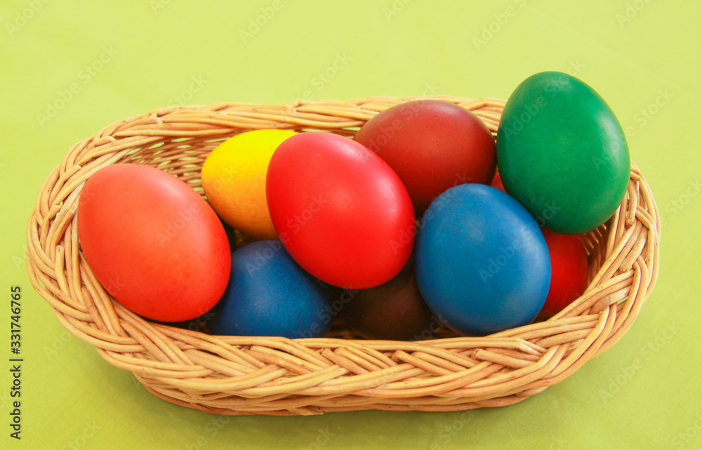 Easter eggs colors in basket green background
