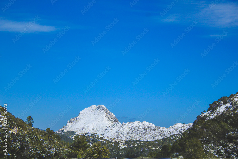 view of Serra de Tramuntana with snow capped mountains in Mallorca, Spain