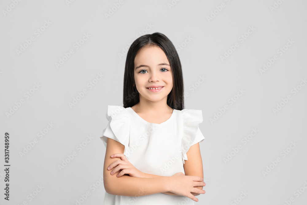 Portrait of cute little girl on light grey background Portrait of cute little girl on light grey background