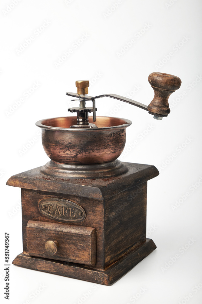 Photo of an antique coffee grinder isolated on a white background. Photo of an antique coffee grinder isolated on a white background.