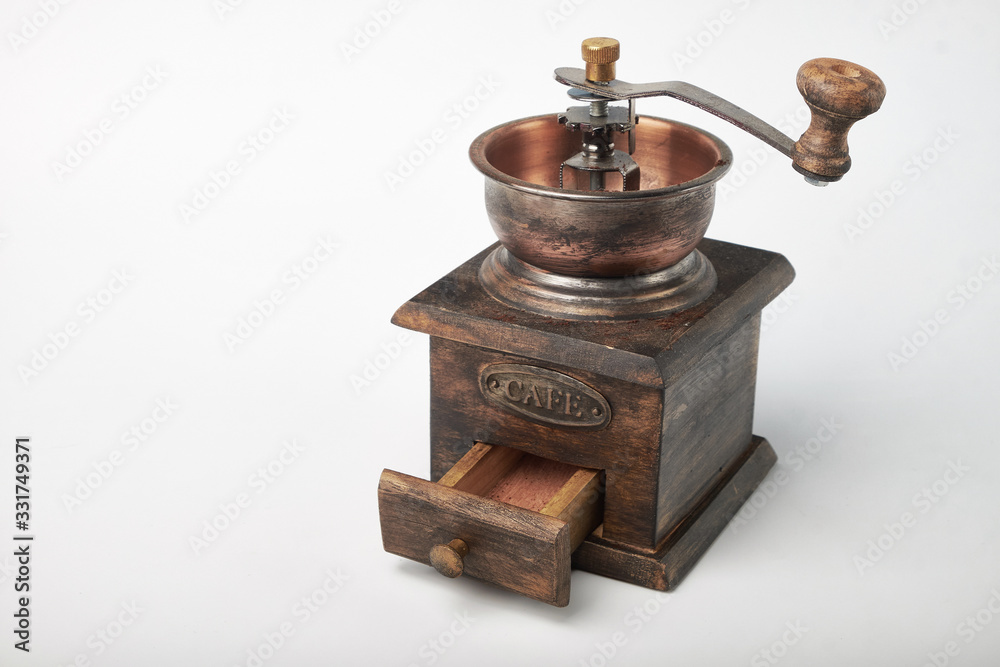 Photo of an antique coffee grinder isolated on a white background. Photo of an antique coffee grinder isolated on a white background.