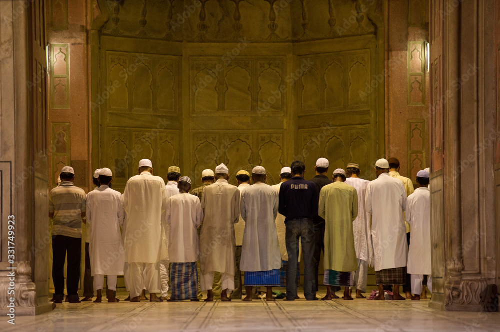 Muslim men pray at Jama Masjid, largest mosque in Asia-Delhi, India