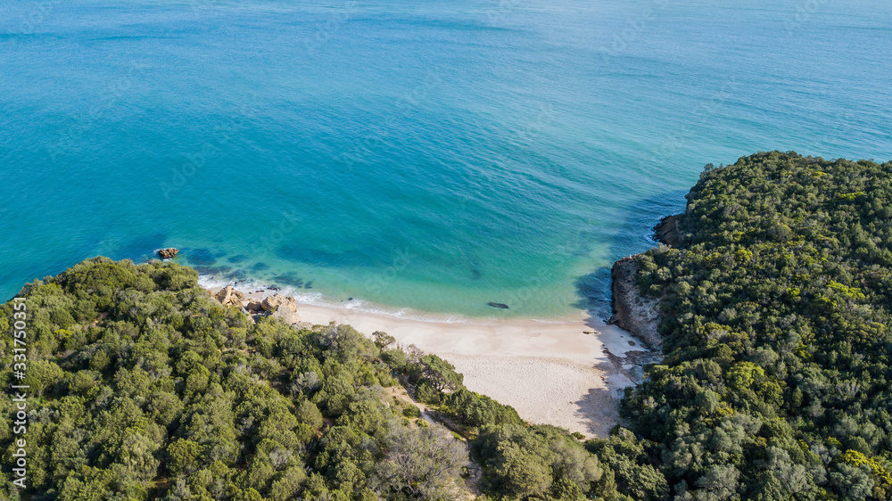 Aerial view of Coelhos beach. Beautiful beaches with transparent waters in Arrábida, in Setúbal, Portugal.