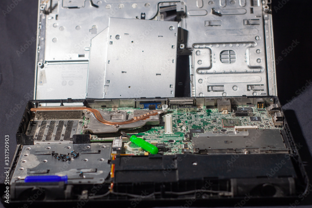 repairing a broken laptop, unscrewing screws with small screwdrivers repairing a broken laptop, unscrewing screws with small screwdrivers