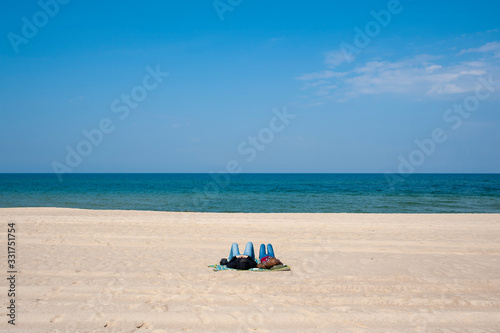 Young couple relaxing on the beach. Spring sunny day