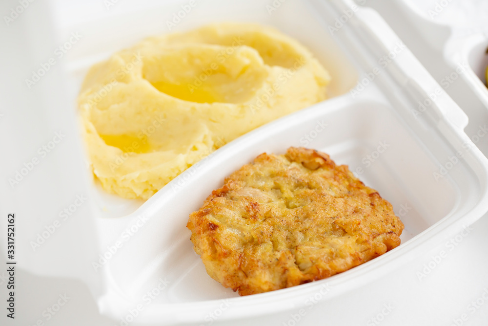 food delivery in white lunch boxes. Food to go. Mashed potatoes and chicken chop. food delivery in white lunch boxes. Food to go. Mashed potatoes and chicken chop.