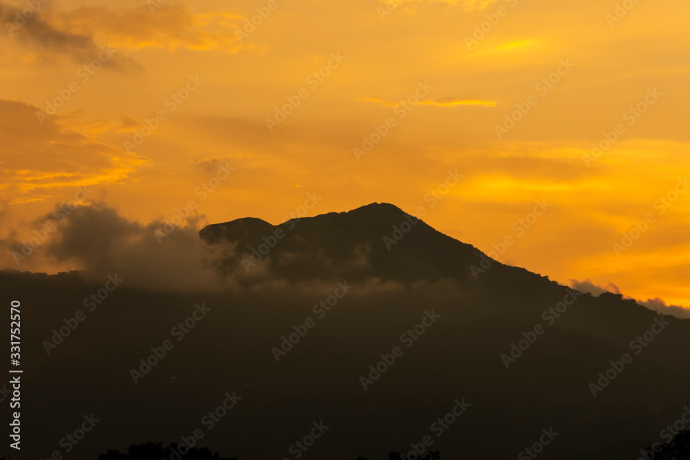 A beautiful sunset with a mountain scape somewhere in Kerala, India A beautiful sunset with a mountain scape somewhere in Kerala, India