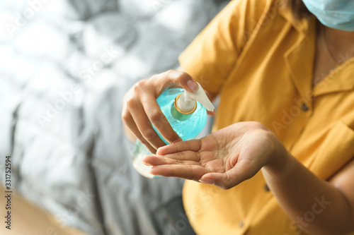 woman washing her hands with alcohol sanitizer gel for protecting infection from a Covid-19 virus and other viruses.