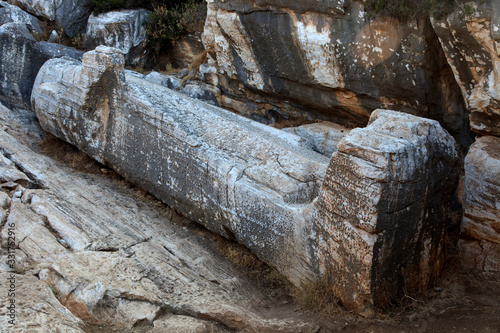 Naxos / Greece - August 25, 2014: Tourist near Giant male statue called Kouros, Naxos, Cyclades Islands, Greece photo