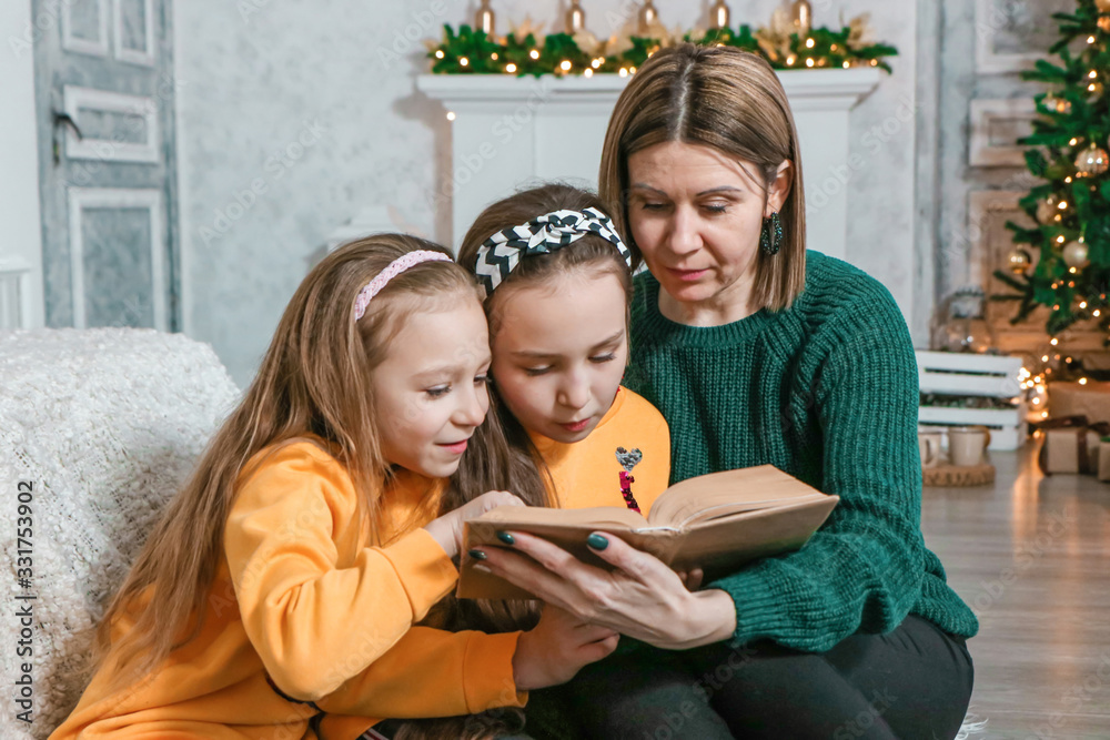 friendly family reading a book at Christmas photo friendly family reading a book at Christmas photo