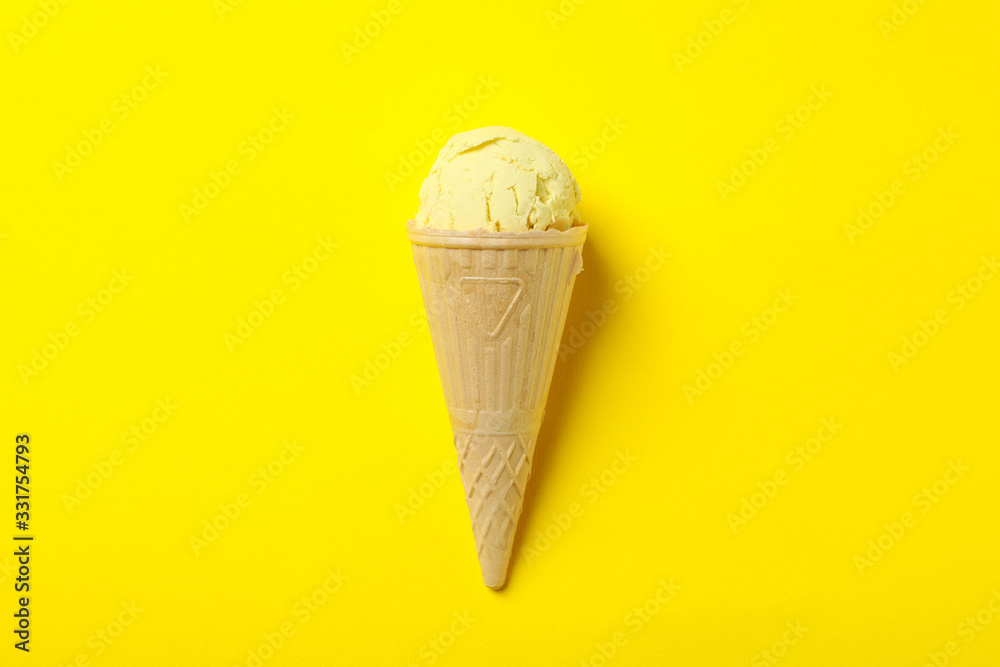 Ice cream in waffle on yellow background, space for text Ice cream in waffle on yellow background, space for text