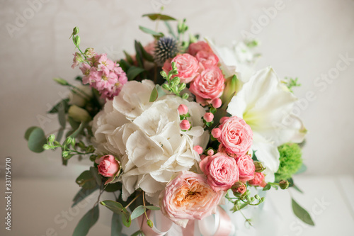 A large flower arrangement in a hat box was created by a florist for a wedding gift. Hydrangea, amarallis, roses and eucalyptus in a bouquet © Iryna